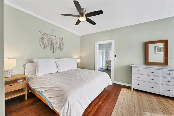 a bedroom with furniture and a wooden floor