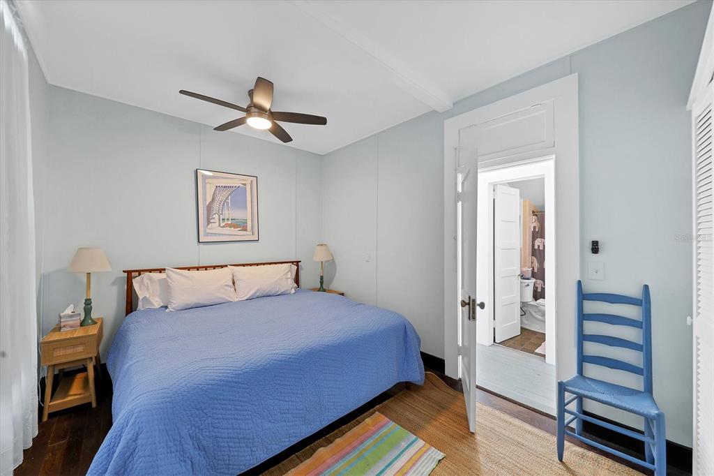 231 Gilchrist Avenue Boca Grande, FL 33921 - Photo 28 of 53 a bedroom with a bed and wooden floor