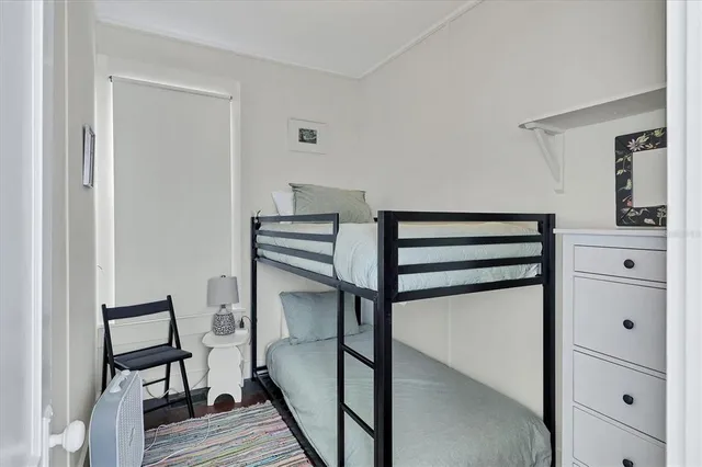 a bedroom with a bunk bed and a dresser