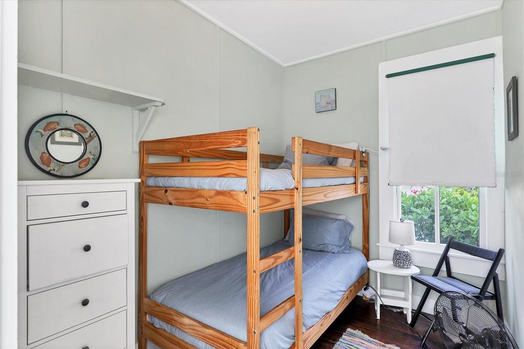 231 Gilchrist Avenue Boca Grande, FL 33921 - Photo 31 of 53 a bedroom with a bunk bed and a dresser
