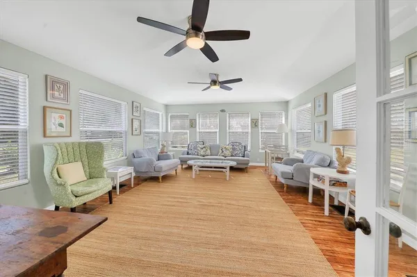 a living room with furniture and a wooden floor