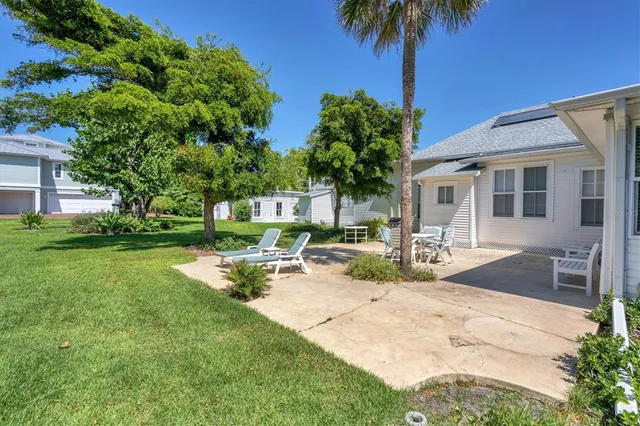 a front view of a house with garden and sitting area