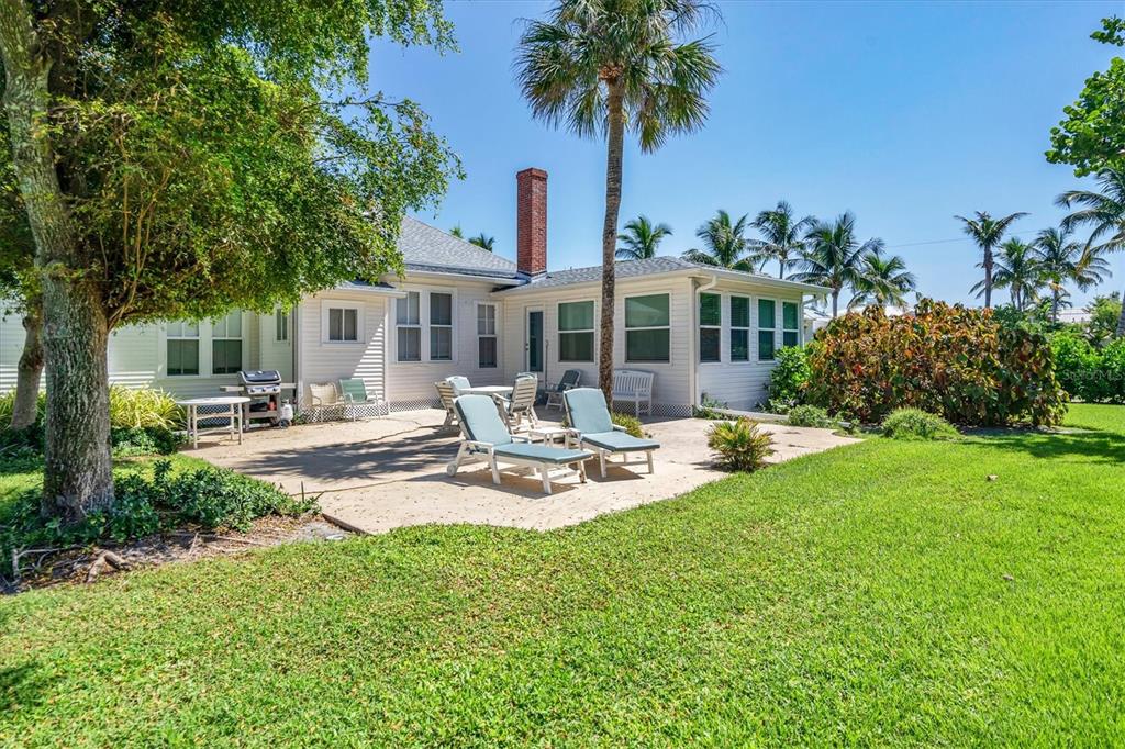 231 Gilchrist Avenue Boca Grande, FL 33921 - Photo 38 of 53 a front view of a house with garden and sitting area