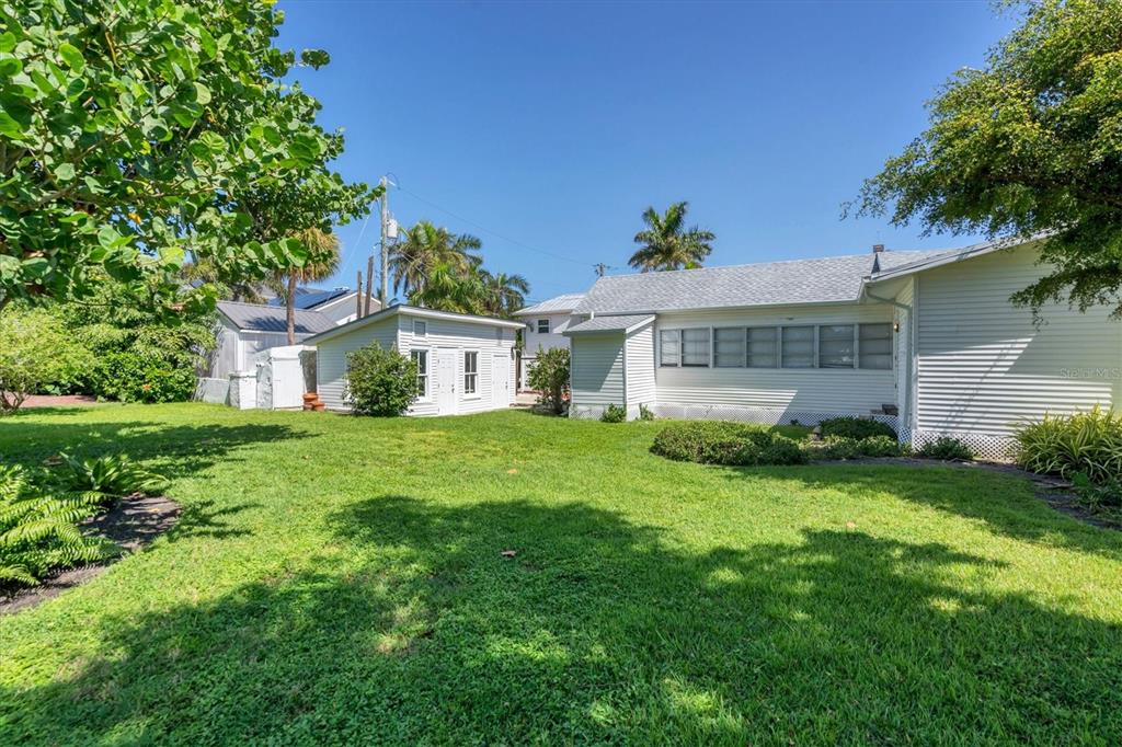 231 Gilchrist Avenue Boca Grande, FL 33921 - Photo 41 of 53 a view of a house with a big yard and potted plants