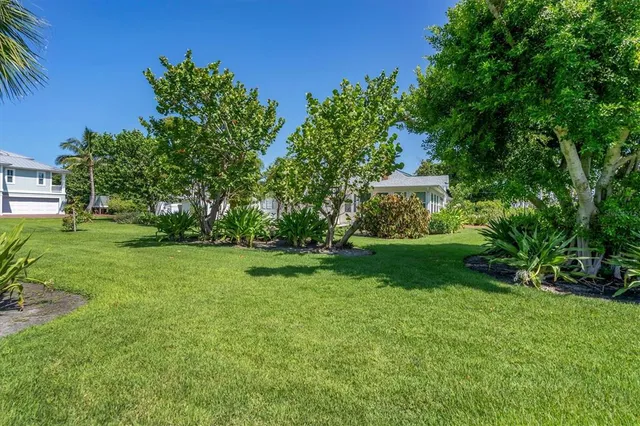 a view of house with backyard space and garden