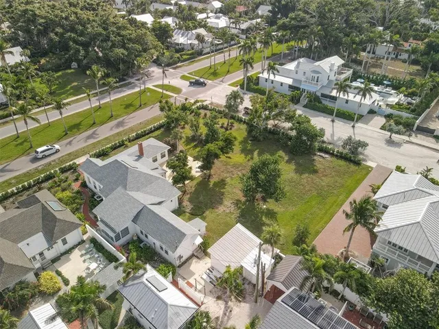 an aerial view of a residential houses with outdoor space and street view
