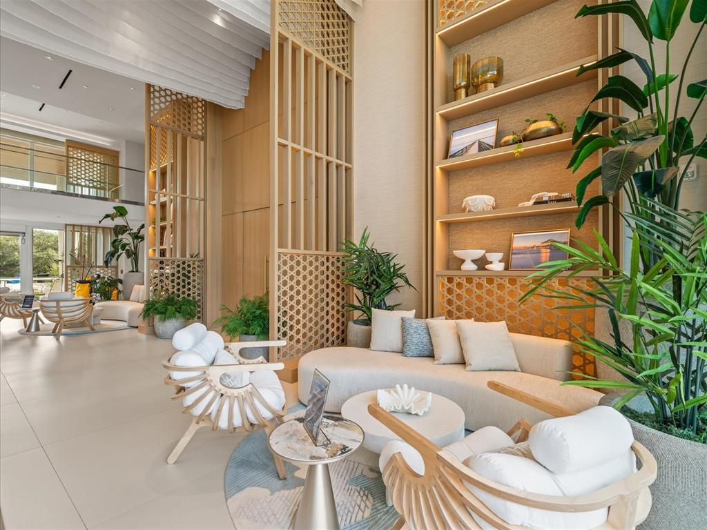 1020 Sunset Point Road, Unit 511 Clearwater, FL 33755 - Photo 33 of 99 a living room with patio furniture and a potted plant