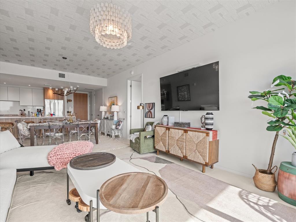 1020 Sunset Point Road, Unit 511 Clearwater, FL 33755 - Photo 77 of 99 a living room with furniture and a flat screen tv