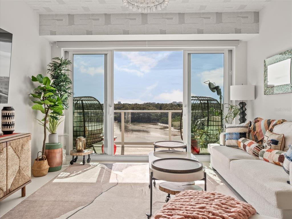 1020 Sunset Point Road, Unit 511 Clearwater, FL 33755 - Photo 79 of 99 a living room with furniture and a potted plant