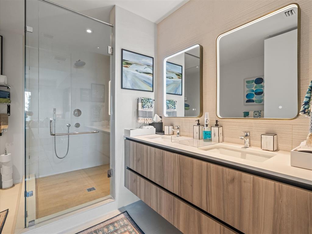 1020 Sunset Point Road, Unit 511 Clearwater, FL 33755 - Photo 89 of 99 a bathroom with a double vanity sink mirror and shower