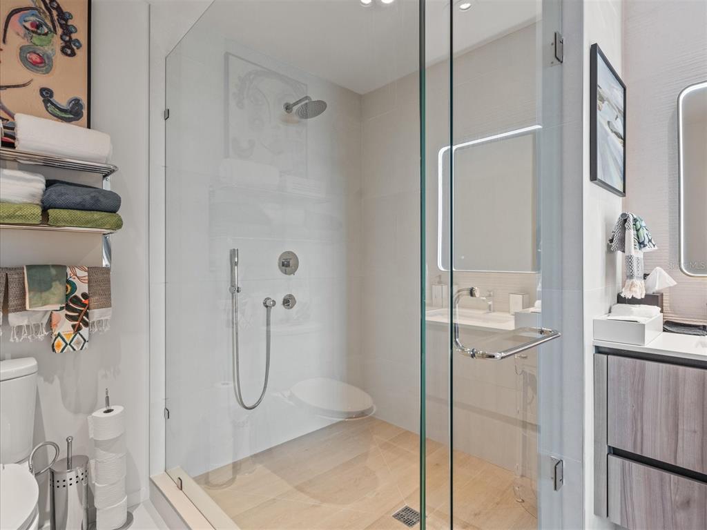 1020 Sunset Point Road, Unit 511 Clearwater, FL 33755 - Photo 90 of 99 a bathroom with a granite countertop shower mirror and a sink