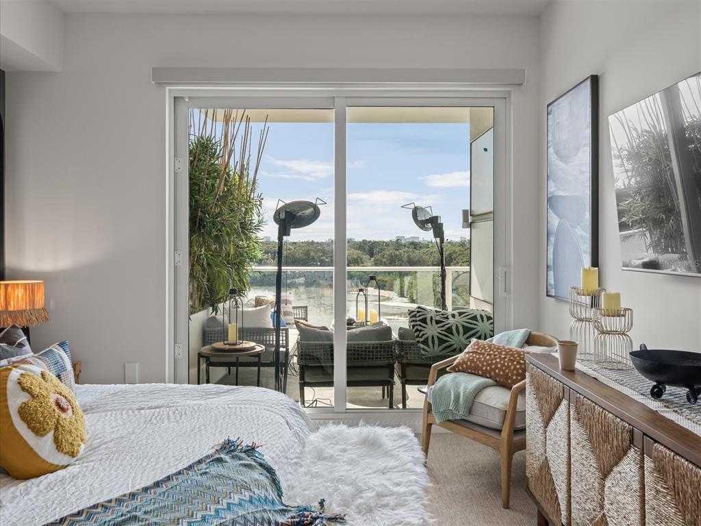 1020 Sunset Point Road, Unit 511 Clearwater, FL 33755 - Photo 92 of 99 a bedroom with furniture and a large window
