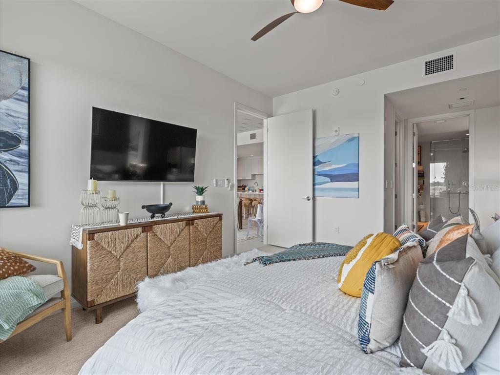 1020 Sunset Point Road, Unit 511 Clearwater, FL 33755 - Photo 93 of 99 a bedroom with bed and tv with wooden floor