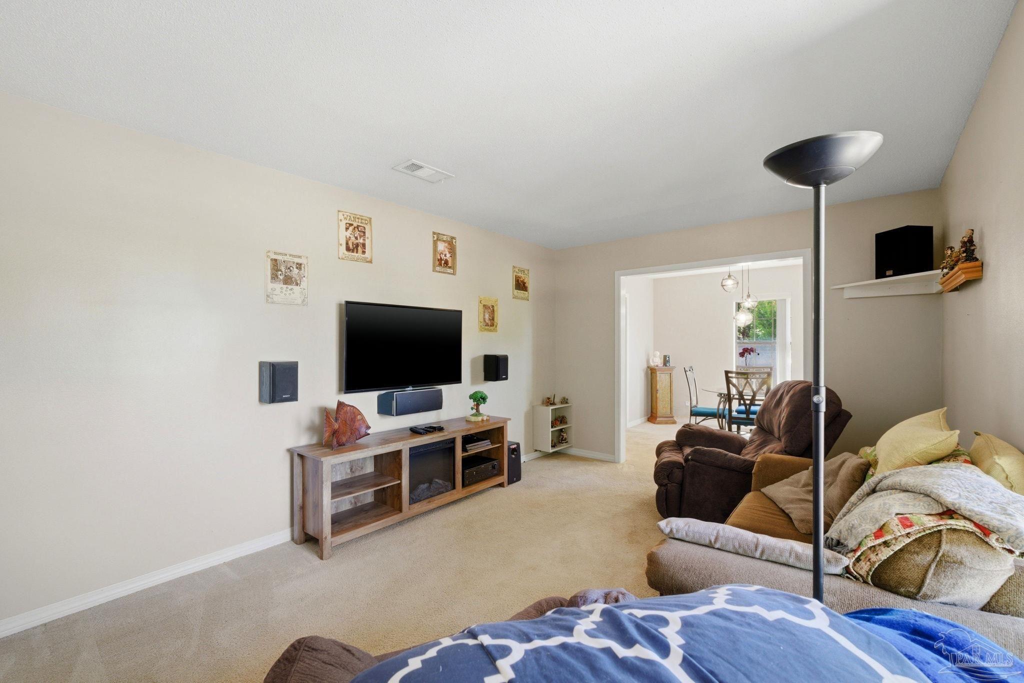5121 Keyser Mill Road Baker, FL 32531 - Photo 25 of 52 a living room with furniture and a flat screen tv