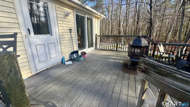 a view of a deck with wooden floor and floor to ceiling window