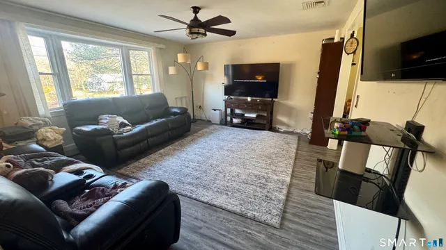 a living room with furniture and a flat screen tv