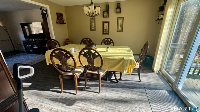 a front view of a house with dining table and chairs