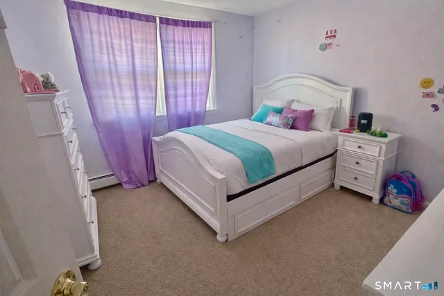 a spacious bedroom with a bed and a window