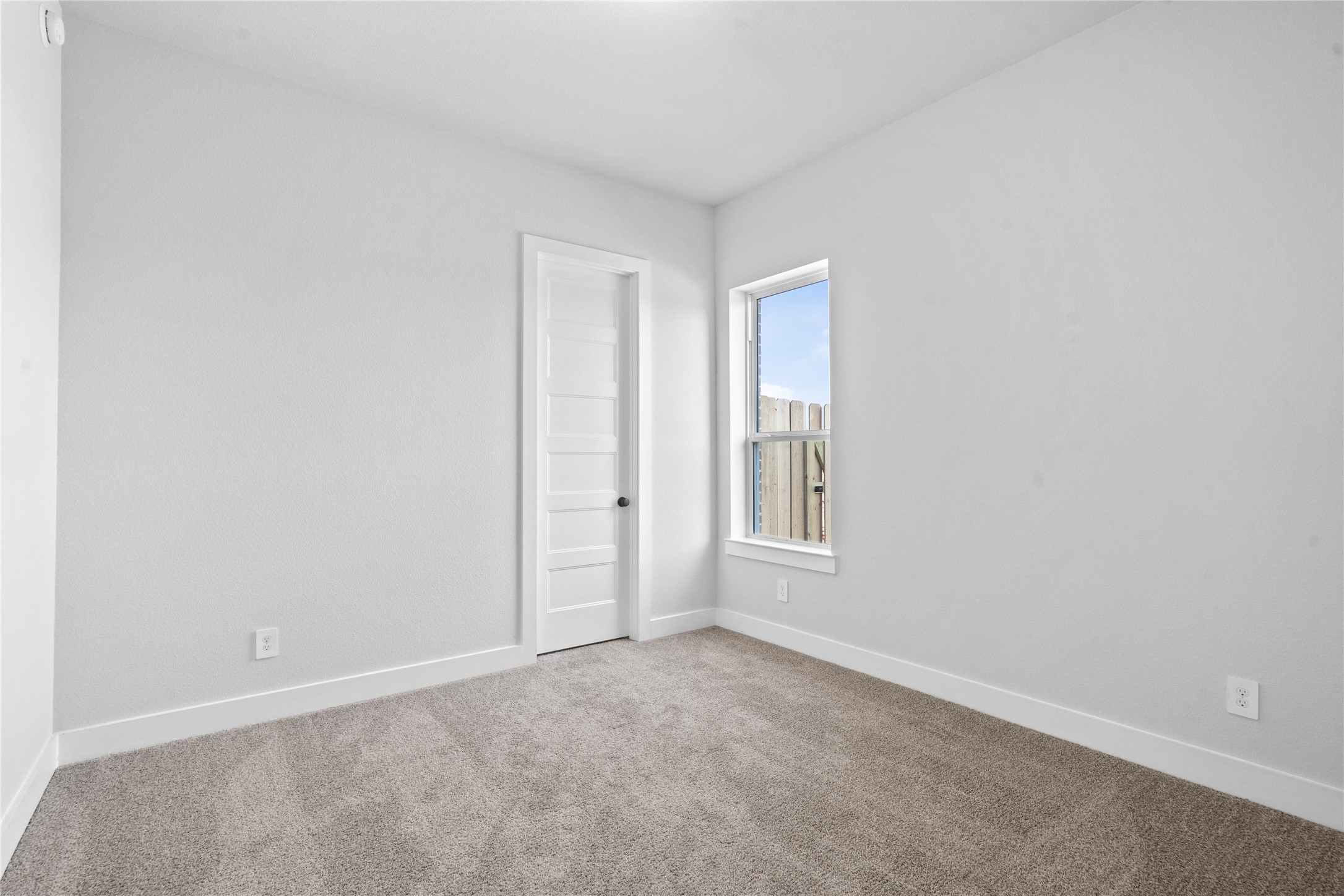 2114 Rowl Street Montgomery, TX 77316 - Photo 14 of 50 This versatile secondary bedroom offers a bright, neutral canvas with plush carpet flooring and light walls, creating a welcoming and adaptable space for a growing family. It also features a walk-in closet!