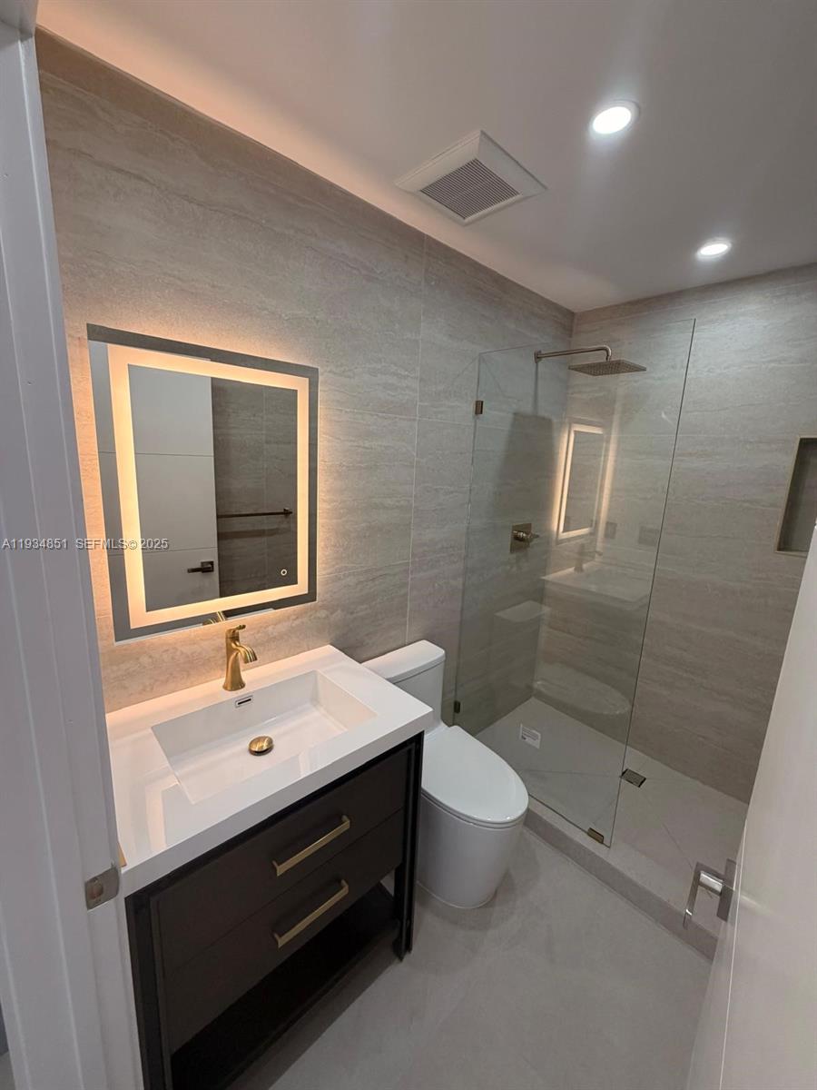 2436 Southwest 7th Street, Unit 4 Miami, FL 33135 - Photo 4 of 17 a bathroom with a sink a toilet and shower