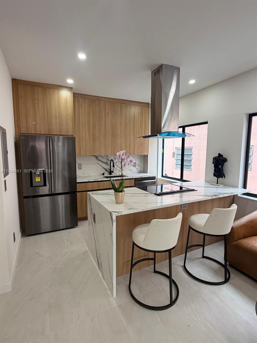 2436 Southwest 7th Street, Unit 4 Miami, FL 33135 - Photo 5 of 17 a kitchen with stainless steel appliances granite countertop a sink a microwave and chairs