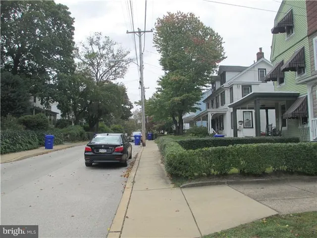 a car parked in front of a brick house