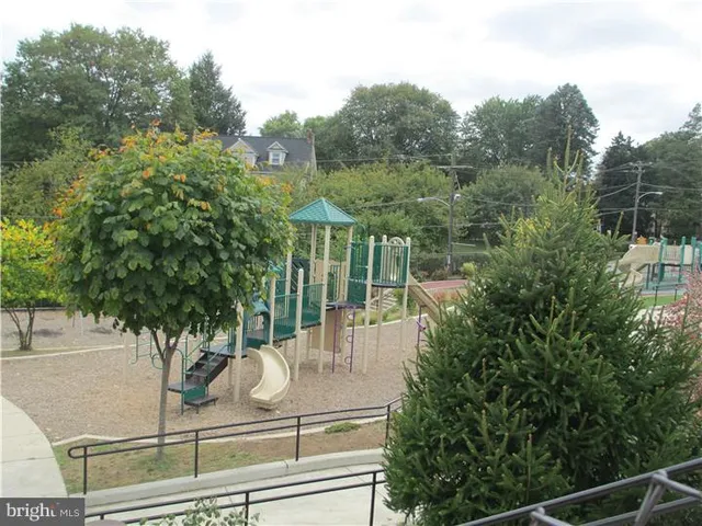 a view of a balcony with floor to ceiling window and wooden fence