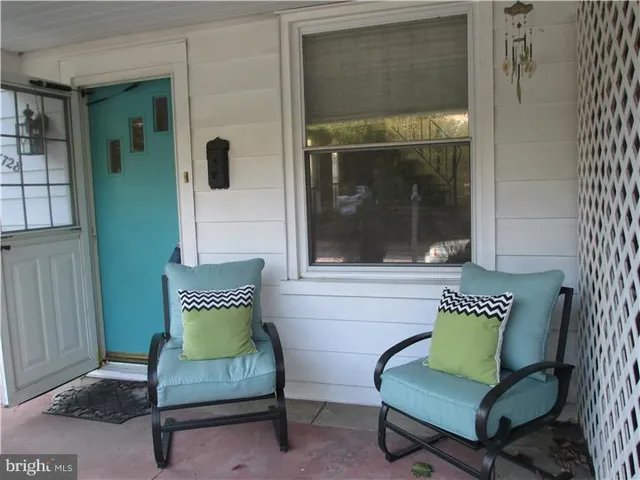 a view of a bedroom with a bench and a bench