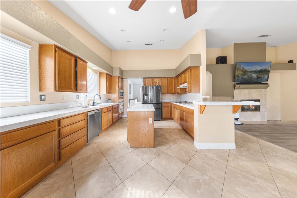 34314 Desert Road Acton, CA 93510 - Photo 19 of 46 a large white kitchen with lots of counter space and windows