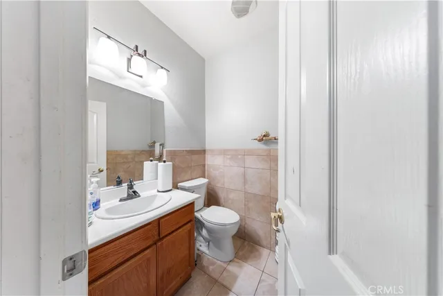 a bathroom with a double vanity sink mirror and toilet