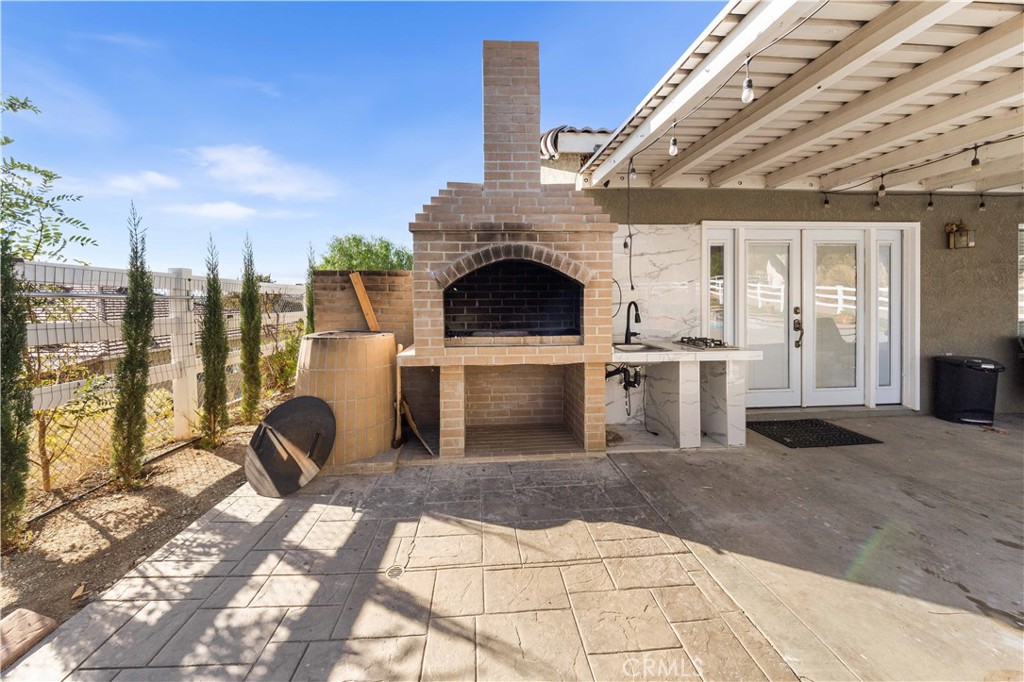 34314 Desert Road Acton, CA 93510 - Photo 38 of 46 a living room with furniture a fireplace and a table
