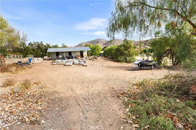 a view of a town with large trees and a fence