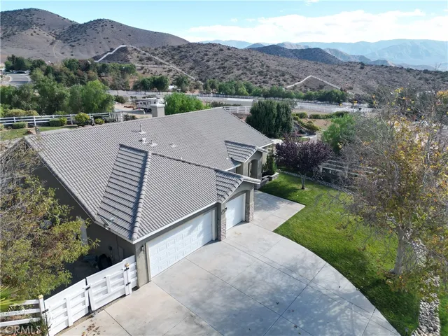 an aerial view of a house with a yard