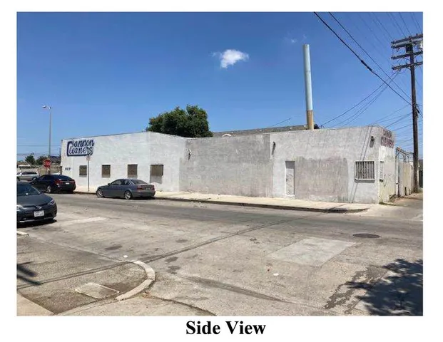 a view of a street with car parked