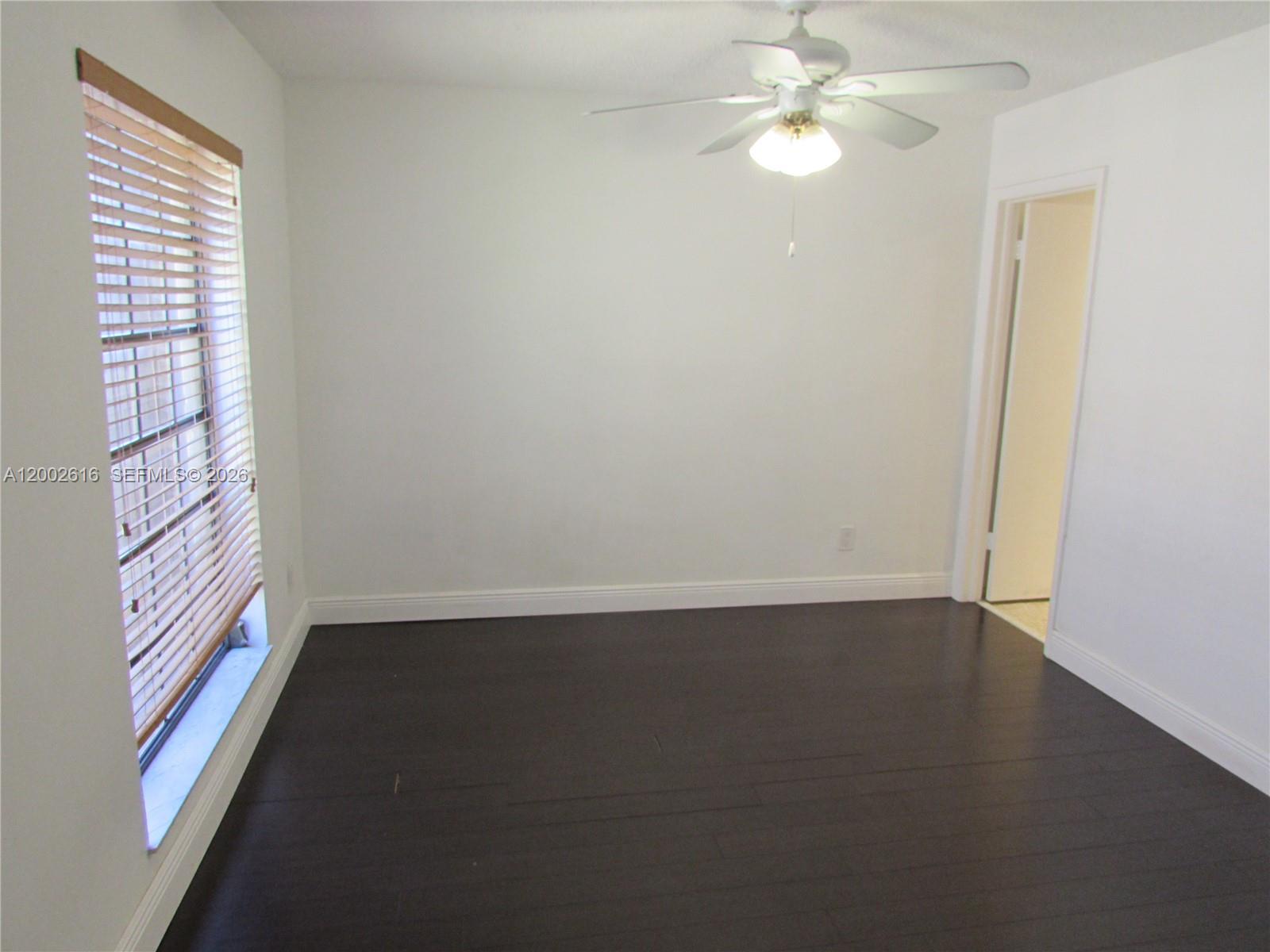 5555 Ludlam Road, Unit 23 South Miami, FL 33155 - Photo 12 of 25 an empty room with windows and fan