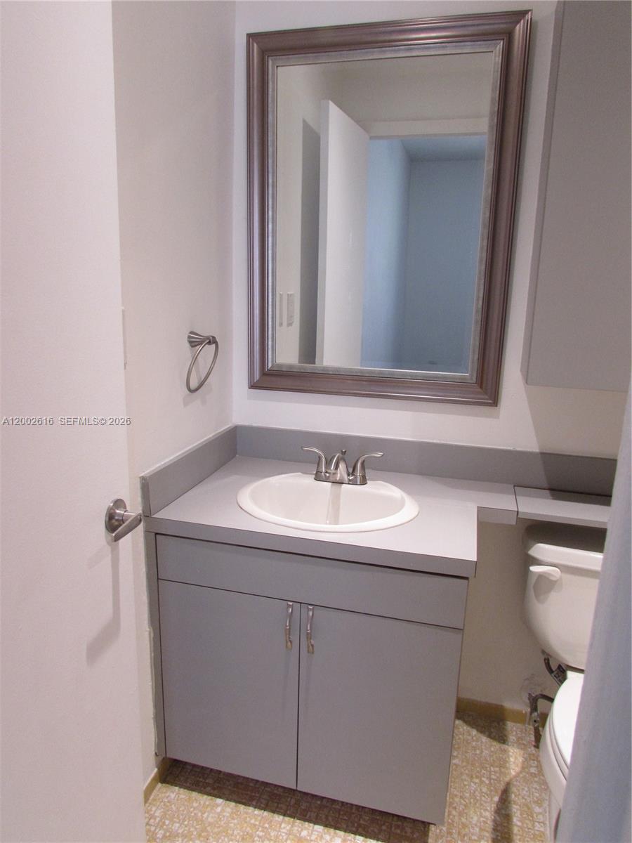 5555 Ludlam Road, Unit 23 South Miami, FL 33155 - Photo 15 of 25 a bathroom with a sink and a toilet