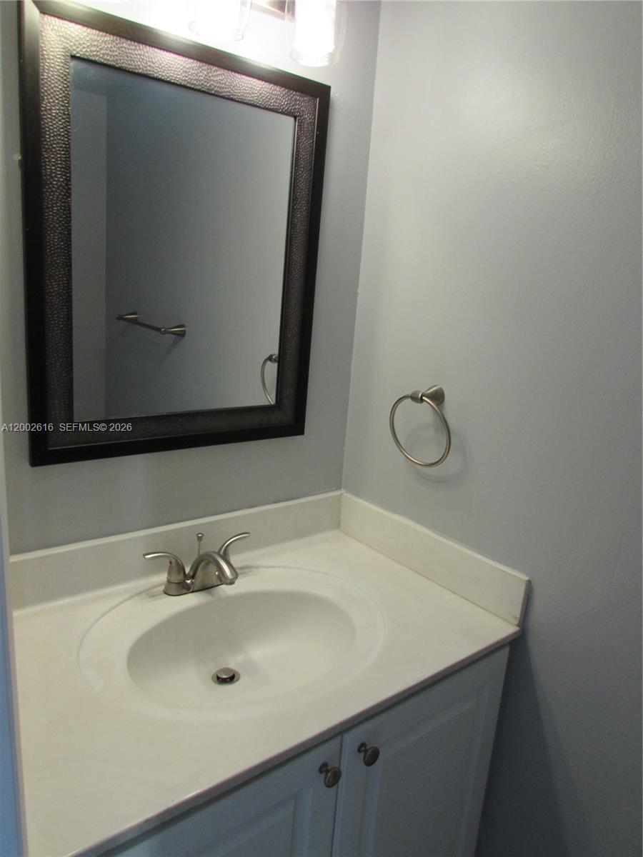 5555 Ludlam Road, Unit 23 South Miami, FL 33155 - Photo 17 of 25 a bathroom with a sink and mirror