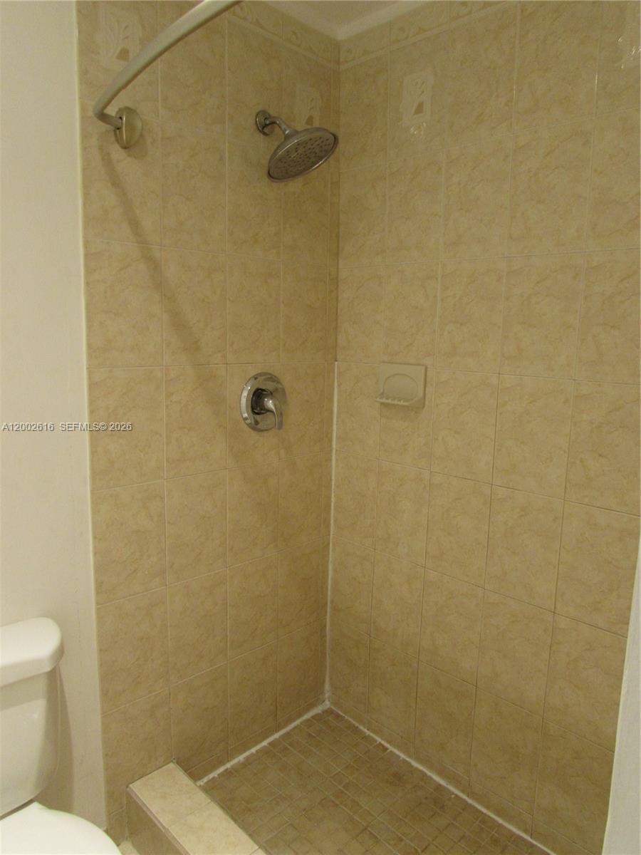 5555 Ludlam Road, Unit 23 South Miami, FL 33155 - Photo 22 of 25 a bathroom with a shower and a toilet