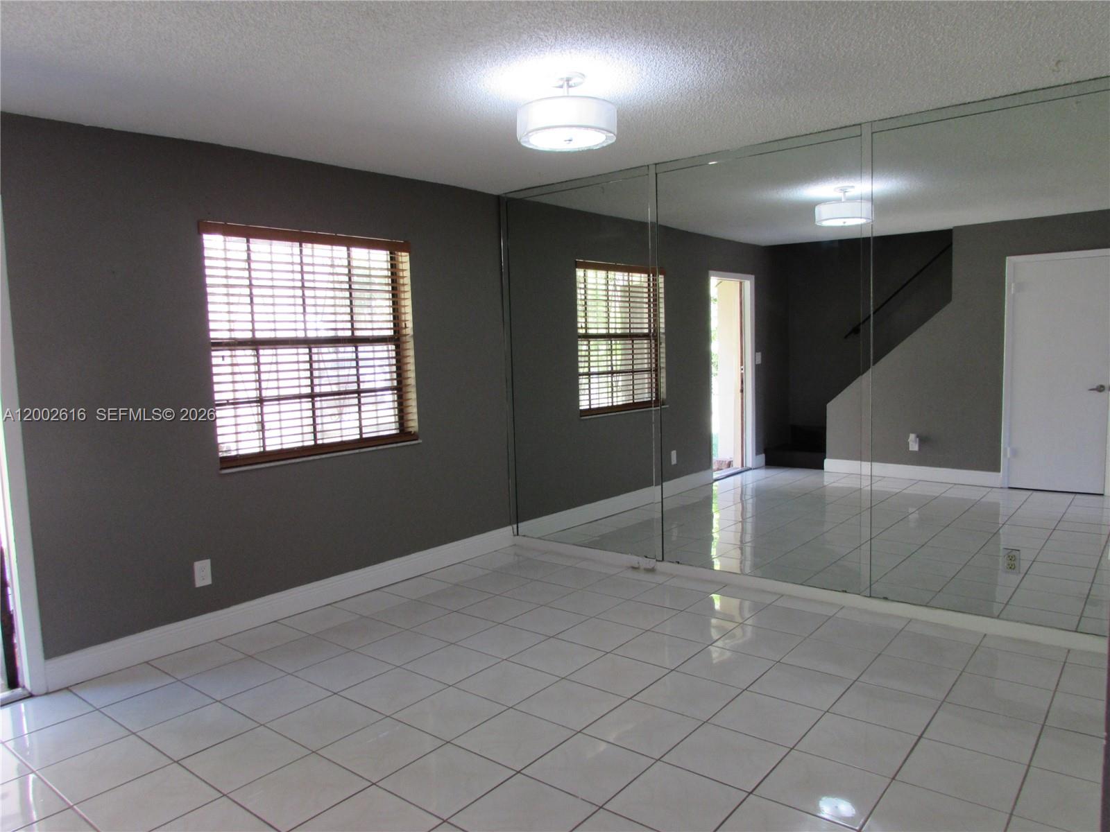 5555 Ludlam Road, Unit 23 South Miami, FL 33155 - Photo 6 of 25 a view of an empty room with windows