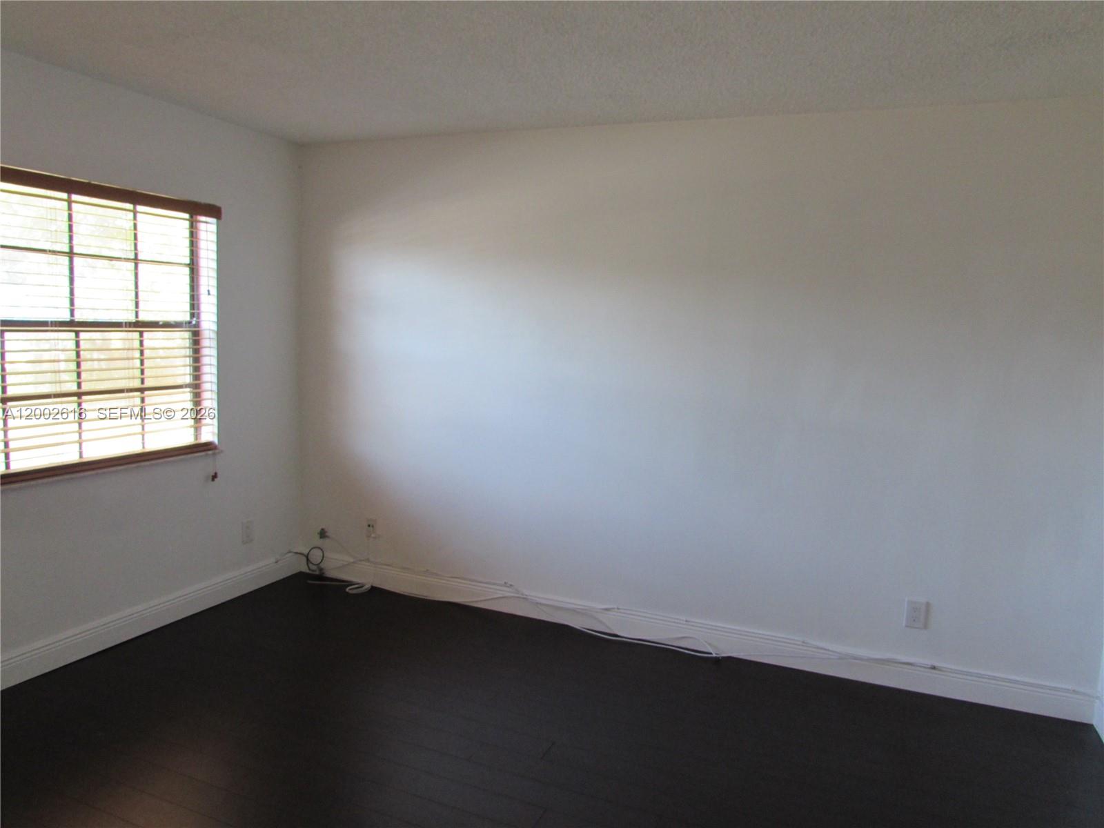 5555 Ludlam Road, Unit 23 South Miami, FL 33155 - Photo 7 of 25 an empty room with a window