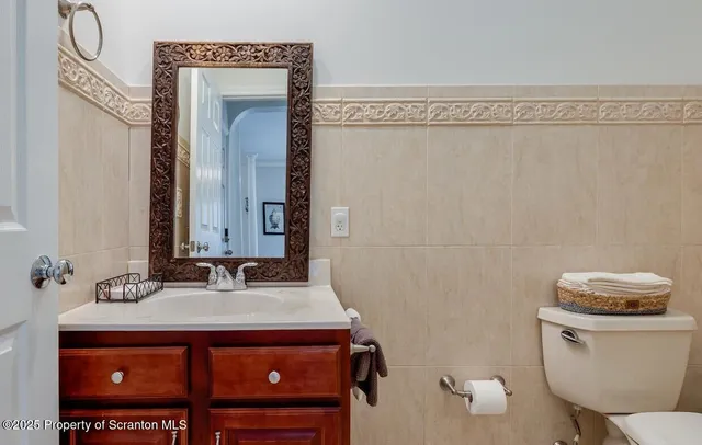 a bathroom with a sink a toilet and mirror
