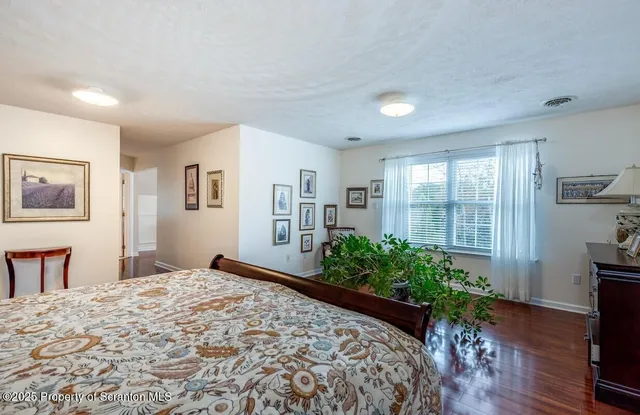 a bed room with a bed and a potted plant