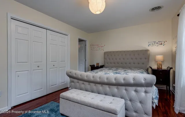 a bedroom with a bed and a lamp