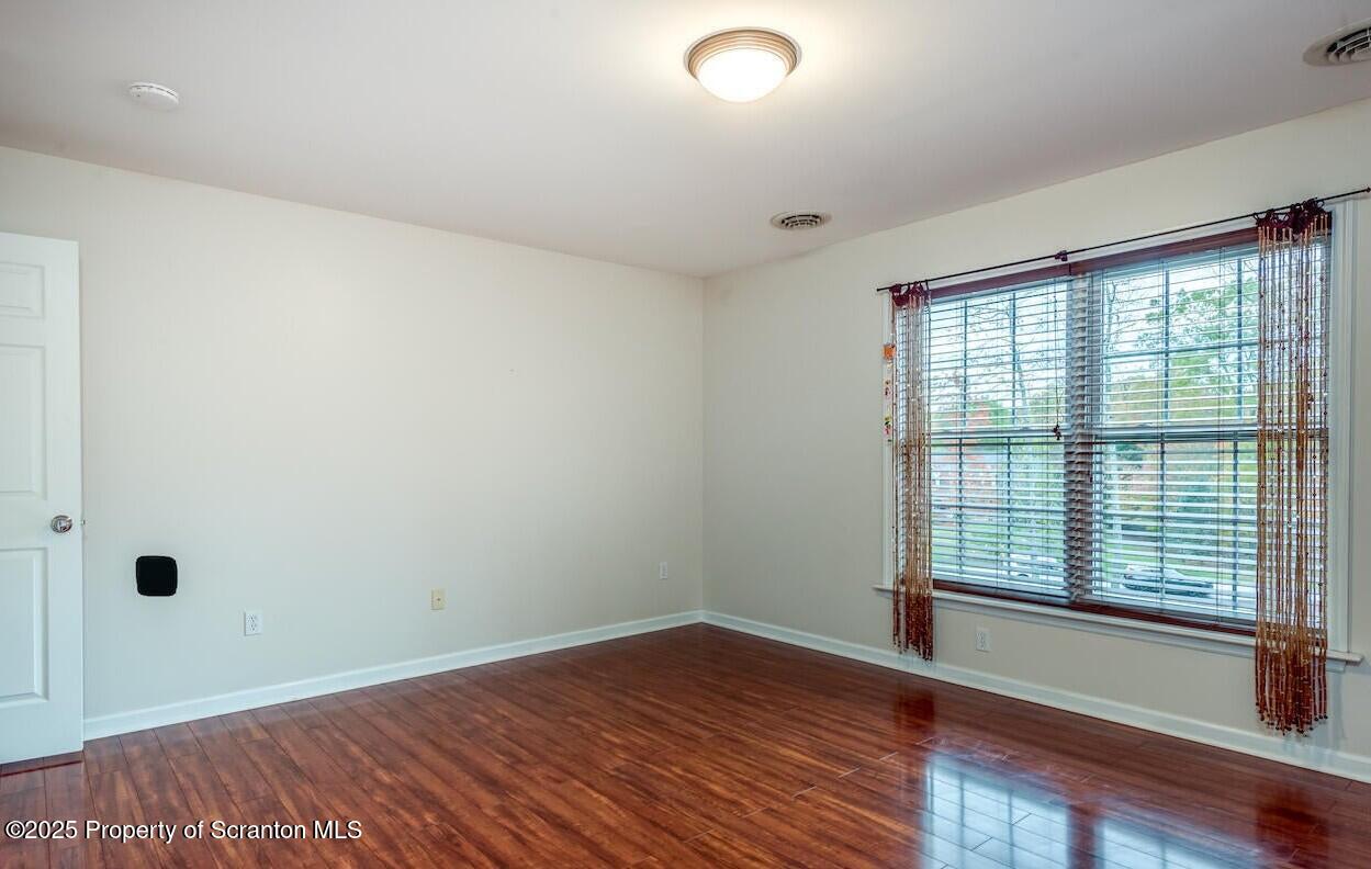 1300 Sandspring Road Wilkes Barre, PA 18702 - Photo 20 of 26 wooden floor in an empty room with a window