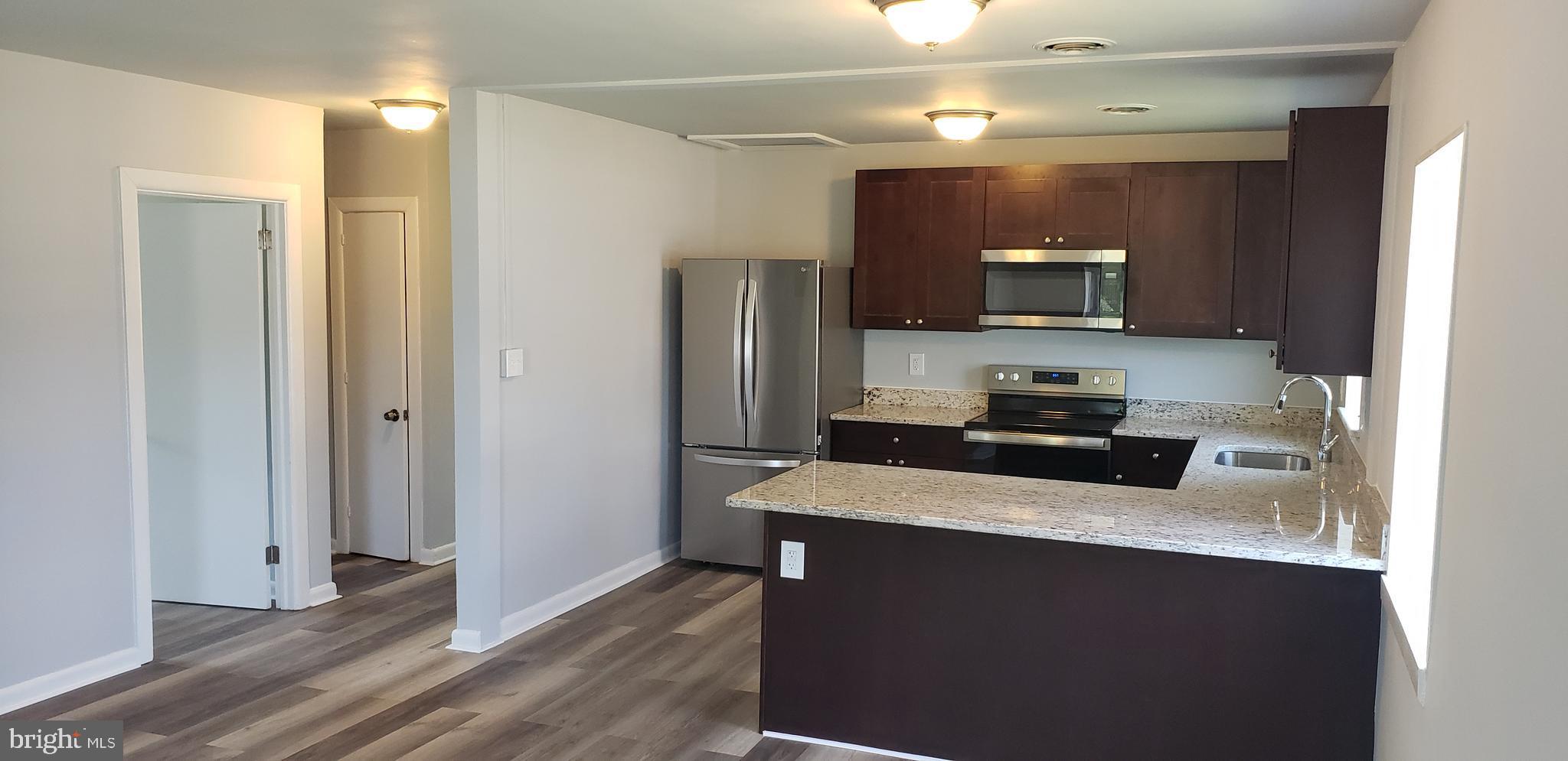 5344 Bucktown Road Cambridge, MD 21613 - Photo 4 of 15 Open great room , kitchen , hallway to bath