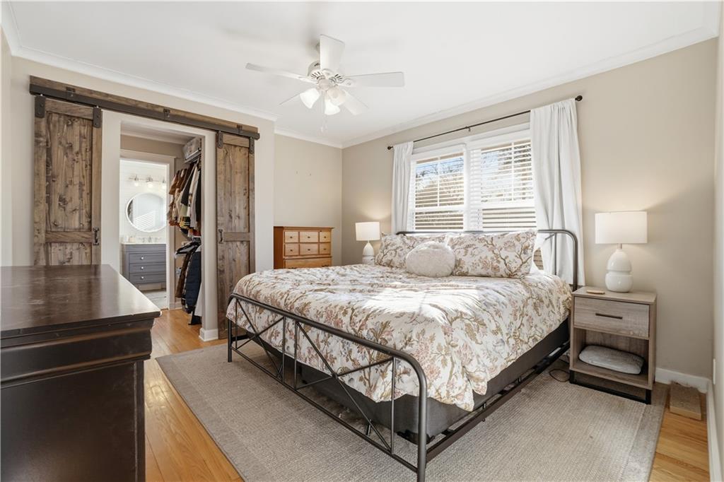 1394 North Druid Hills Road Northeast Brookhaven, GA 30319 - Photo 20 of 38 a spacious bedroom with a bed and wooden floor