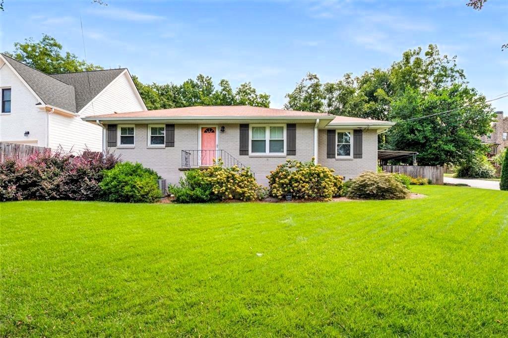 1394 North Druid Hills Road Northeast Brookhaven, GA 30319 - Photo 2 of 38 a front view of a house with a yard