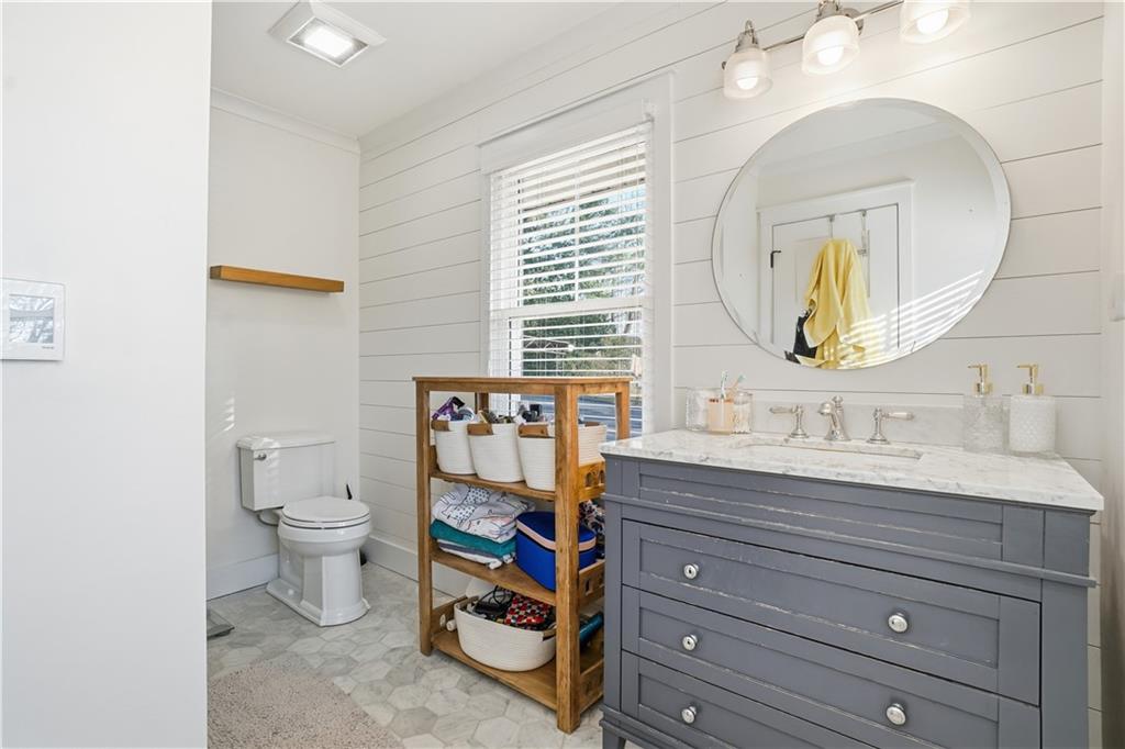 1394 North Druid Hills Road Northeast Brookhaven, GA 30319 - Photo 24 of 38 a bathroom with a toilet a sink and a mirror