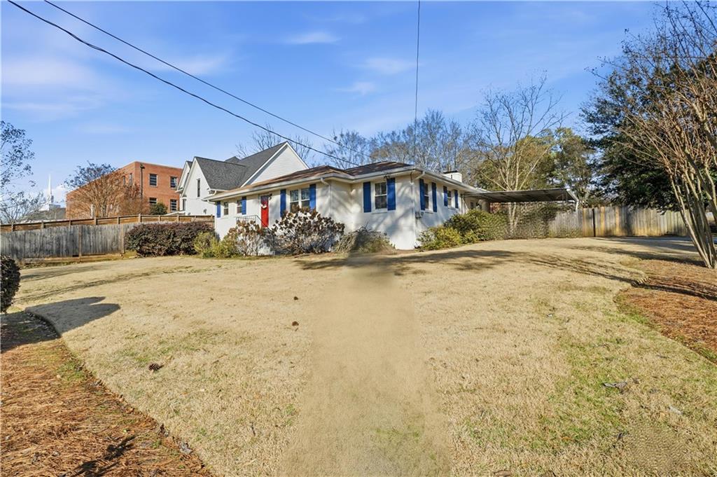 1394 North Druid Hills Road Northeast Brookhaven, GA 30319 - Photo 28 of 38 a front view of a house with a yard