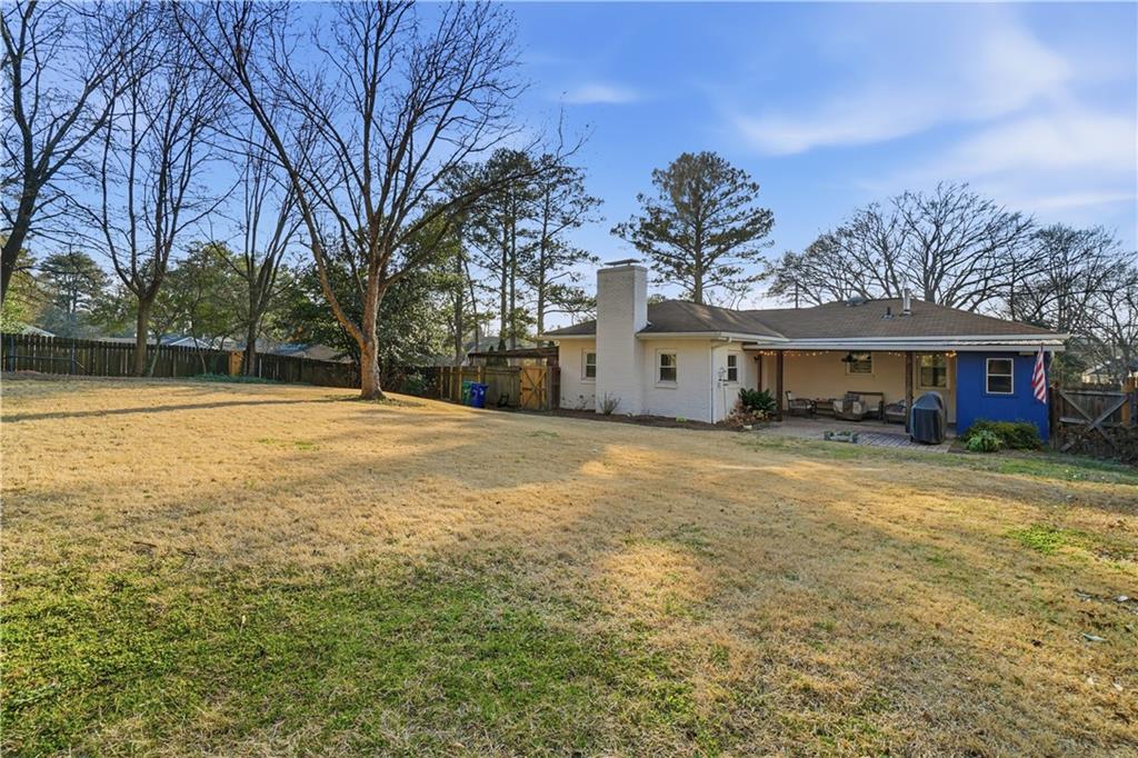 1394 North Druid Hills Road Northeast Brookhaven, GA 30319 - Photo 32 of 38 a front view of house with yard and trees